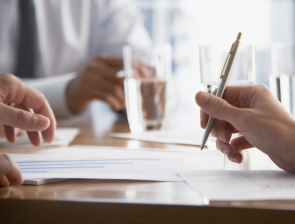 Three businesspeople at a boardroom table